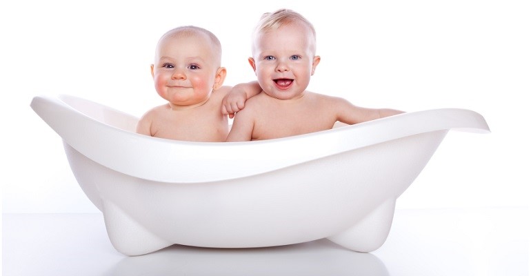 children in white bath tub on white background