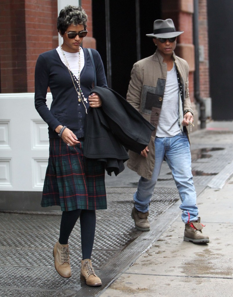 November 01, 2013: Pharrell Williams shows he is a gentleman as he holds the door open for his new wife Helen Lasichanh as they leave their hotel in New York City. Helen wears a tartan kilt similar to what the couple wore on their wedding day. Mandatory Credit: INFphoto.com Ref: infusny-240/141/271|sp|