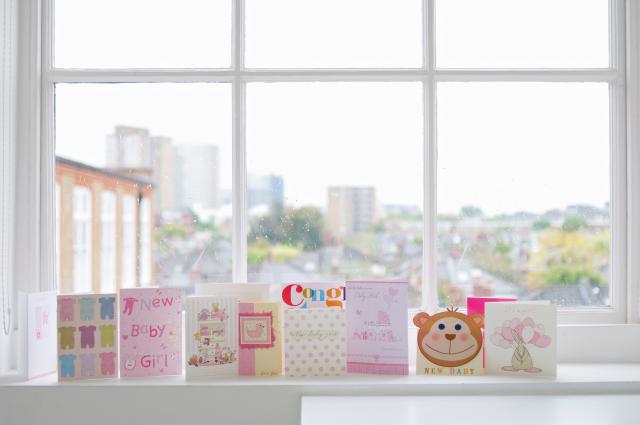 Greetings cards for new baby girl on windowsill